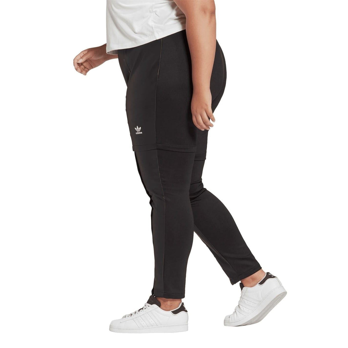 Black slim-fit legging pant with trefoil logo, tapered ankle, and snap-trim details