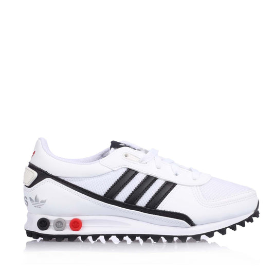 White junior Adidas LA Trainer II sneakers with black stripes and red accent sole.