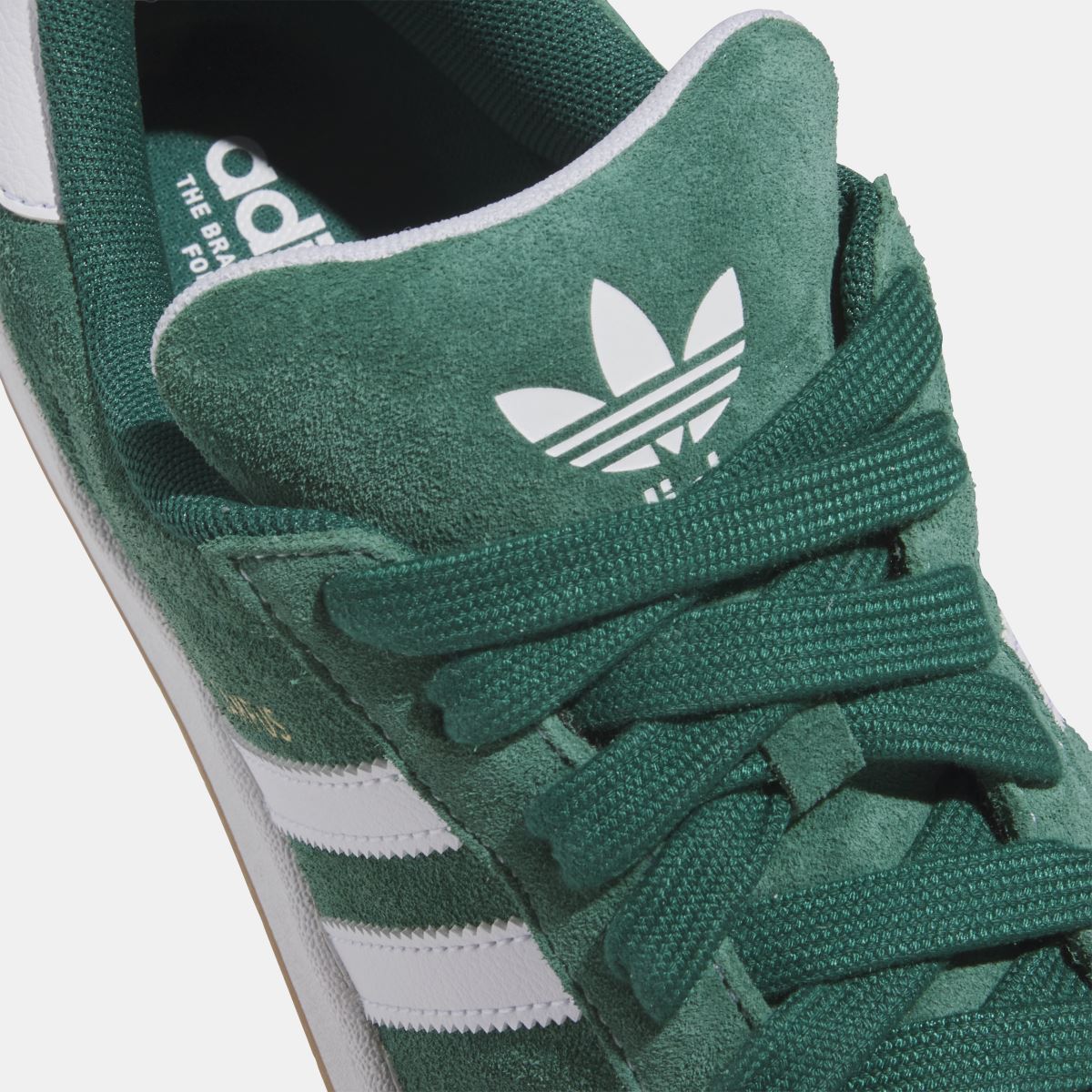 adidas Originals Campus ADV shoes close-up, dark green suede with adidas logo on tongue