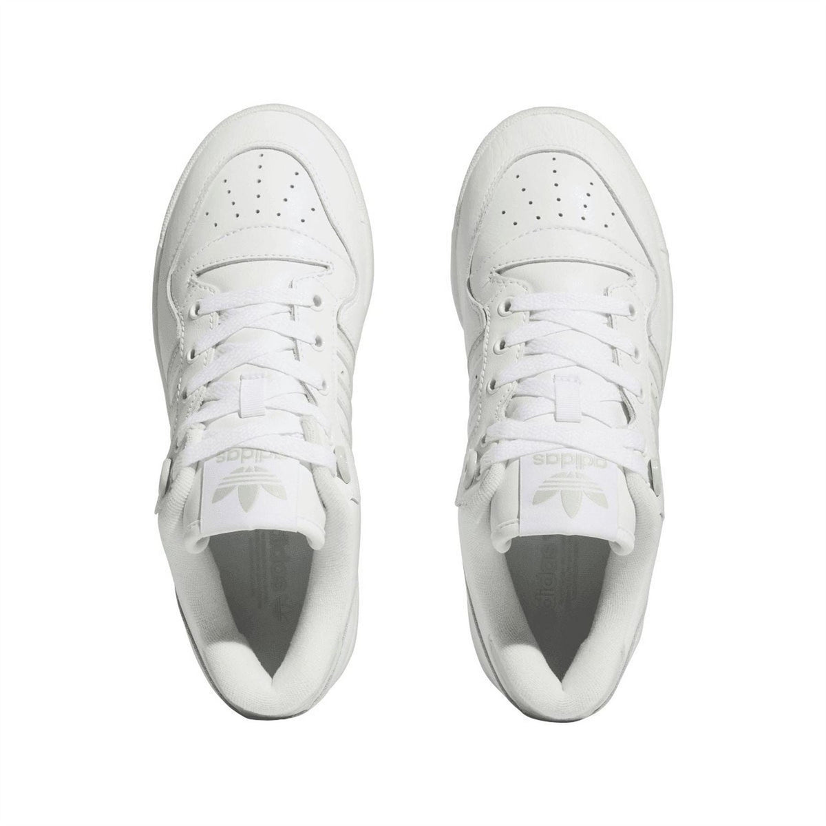 Pair of white low-top sneakers showing toe box eyelets and lace-up openings.