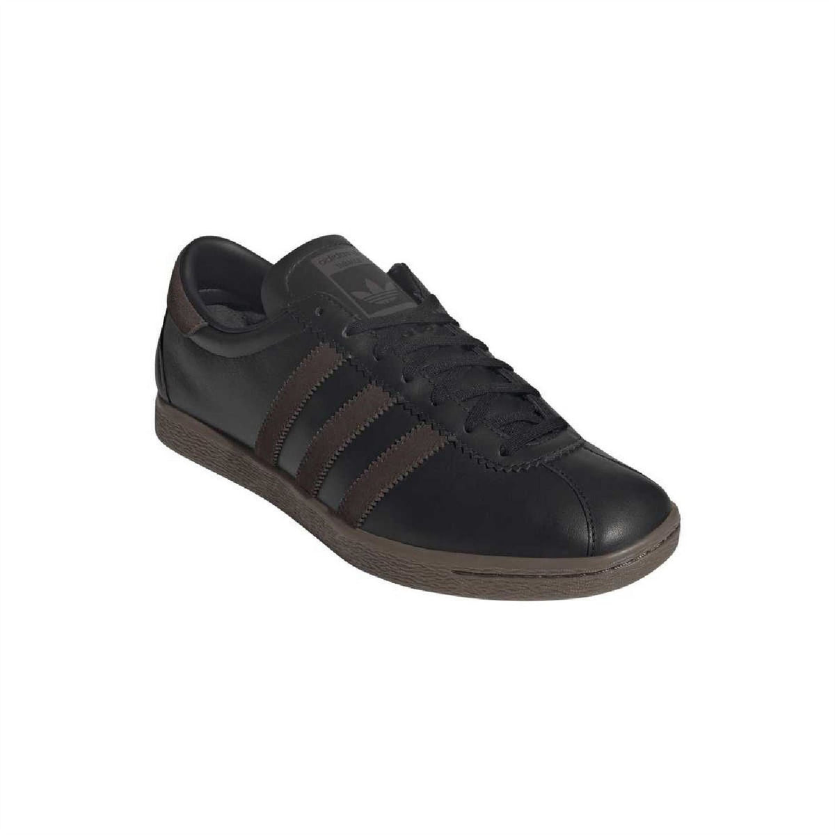 Low-top sneaker angled: black leather, dark brown three stripes, lace-up