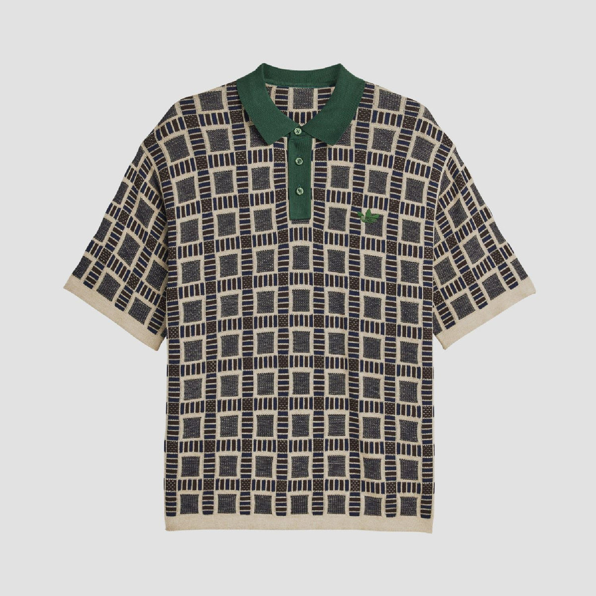 Sand polo shirt with green collar and button placket; navy-and-cream grid pattern.