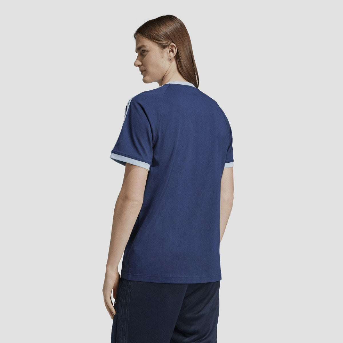 Indigo crew-neck adidas Originals T-shirt shown from back with white sleeve trim