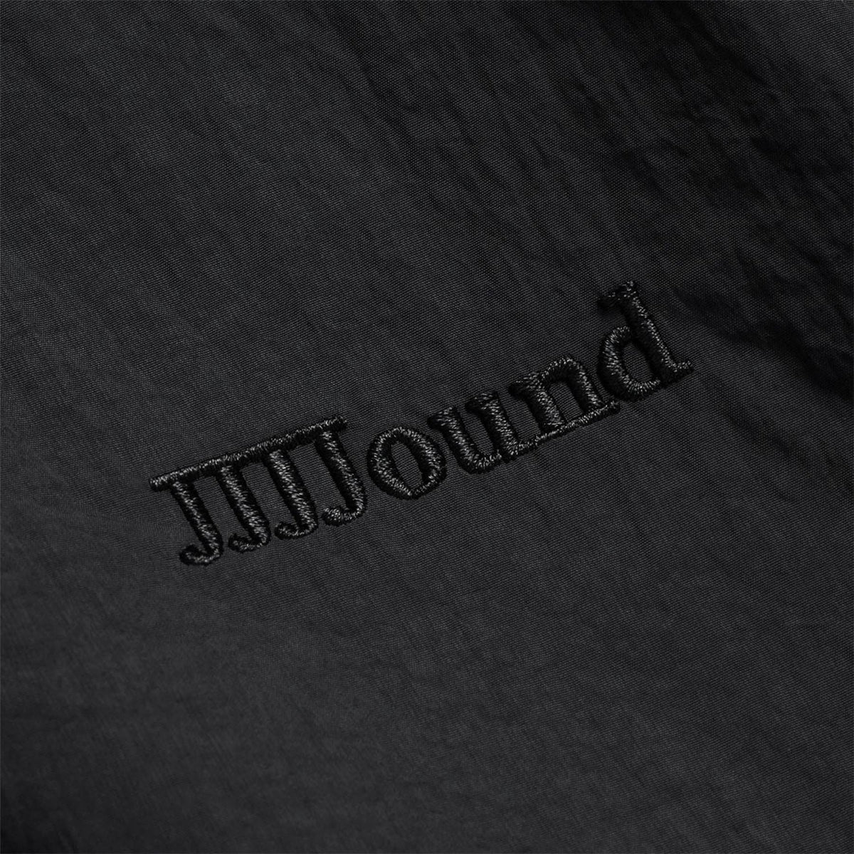 Black embroidered track jacket text detail on chest