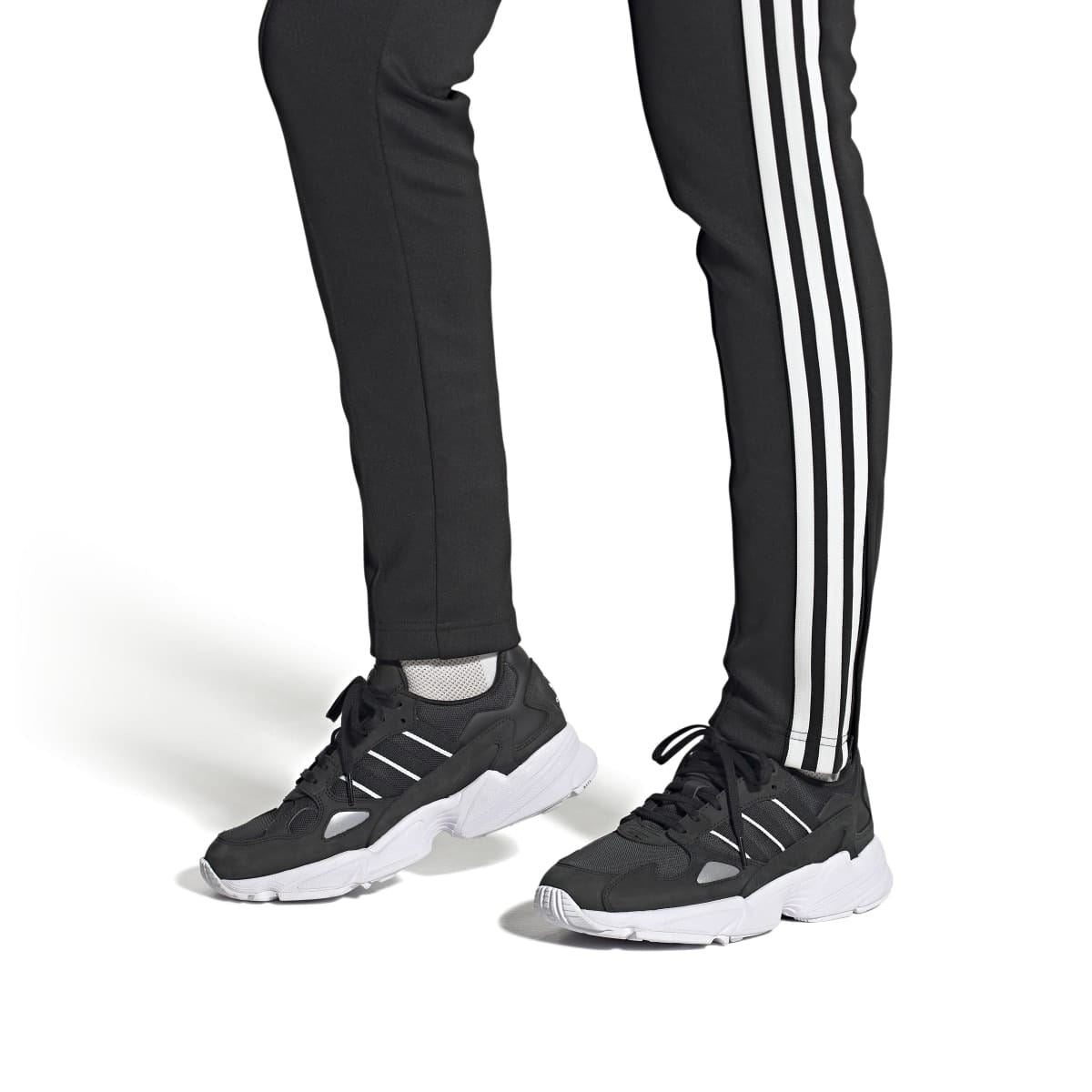 Black adidas Falcon trainers with white triple stripes and chunky white sole