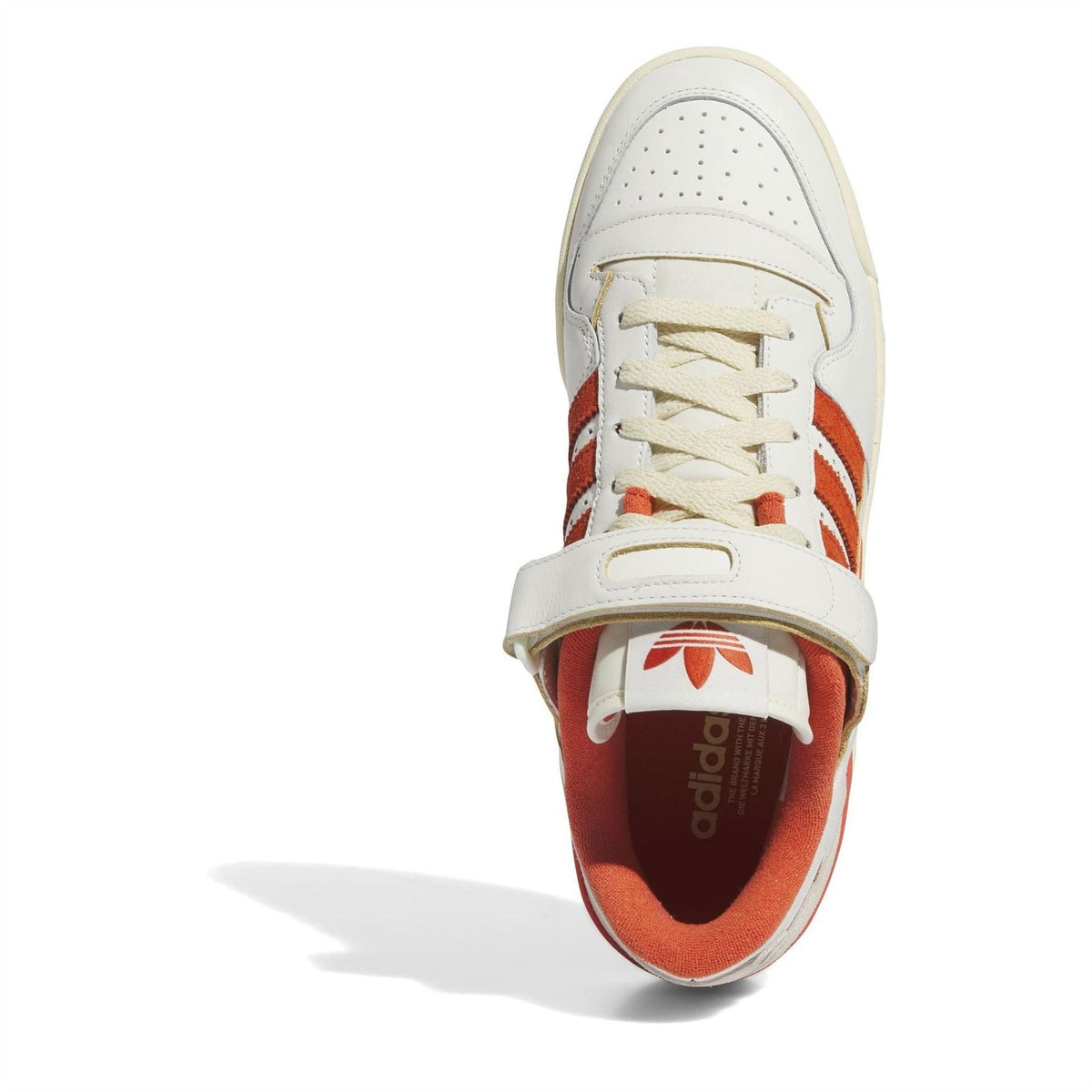 Low-top sneakers: front view with lace-up closure and orange-lined interior