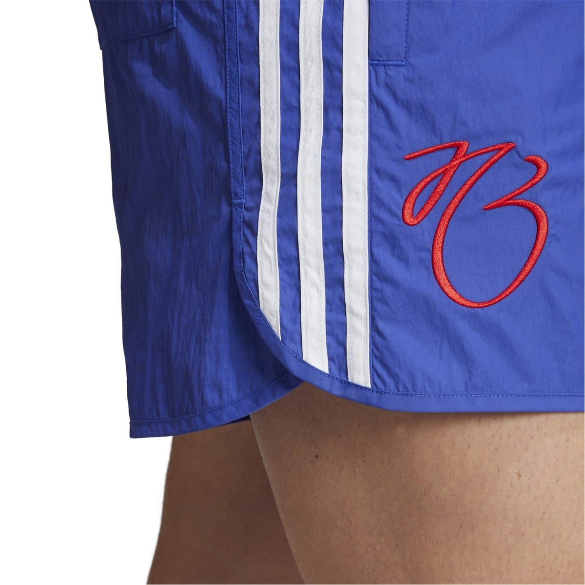 Blue shorts leg panel with white side stripes and red "73" graphic