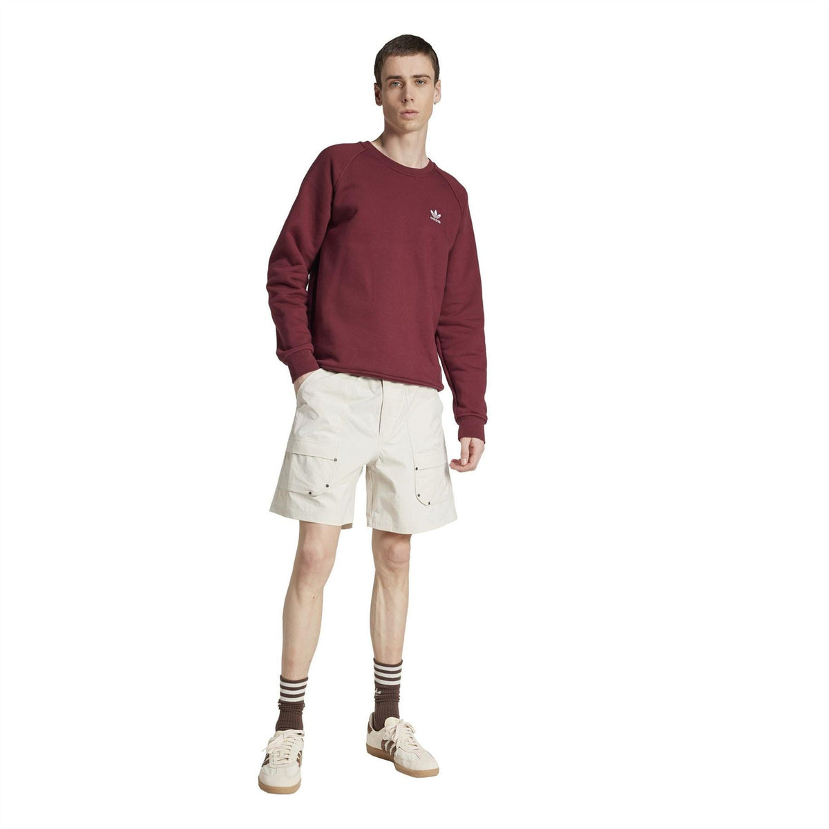 Light off-white knee-length cargo shorts with belt loops and visible side pocket flap