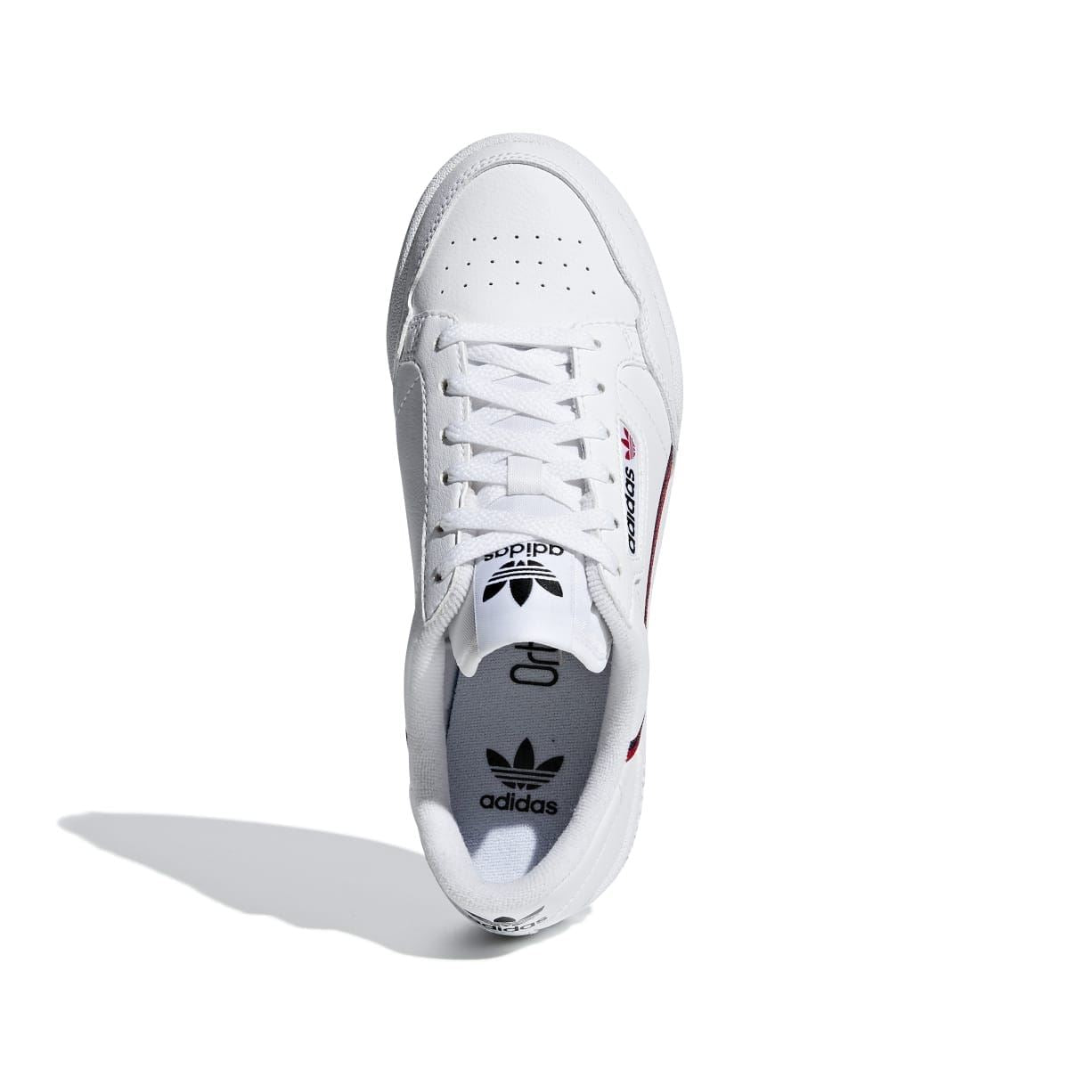 White Adidas Originals Continental 80 junior shoe with lace-up front and perforated toe.