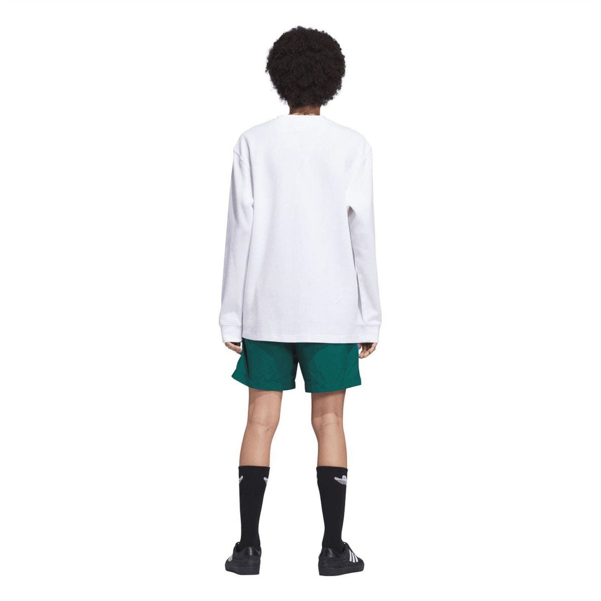 Green water shorts on model, view from back with elastic waistband