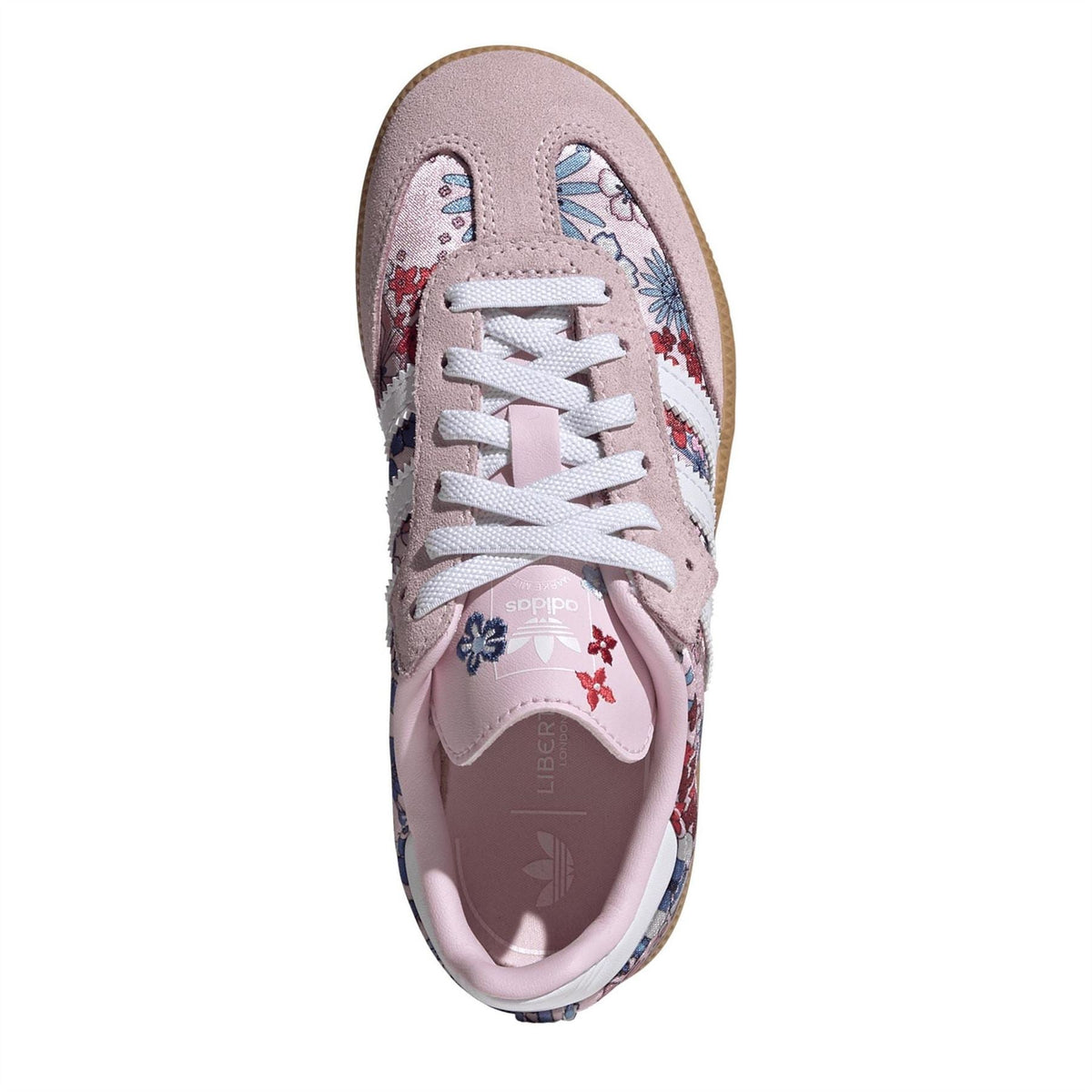 Pink low-top sneakers with floral toe and lace-up closure, cushioned collar.