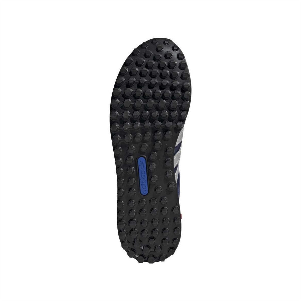 Black adidas outsole with textured tread and blue center label
