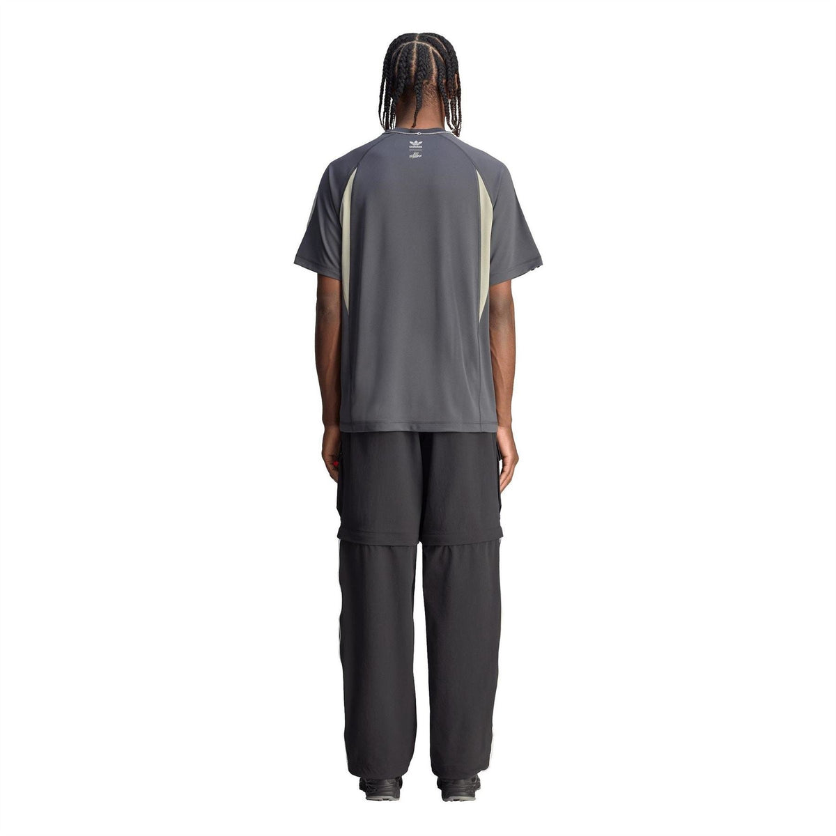 Back view of black fleece jogger pants with cargo pockets and white side stripes