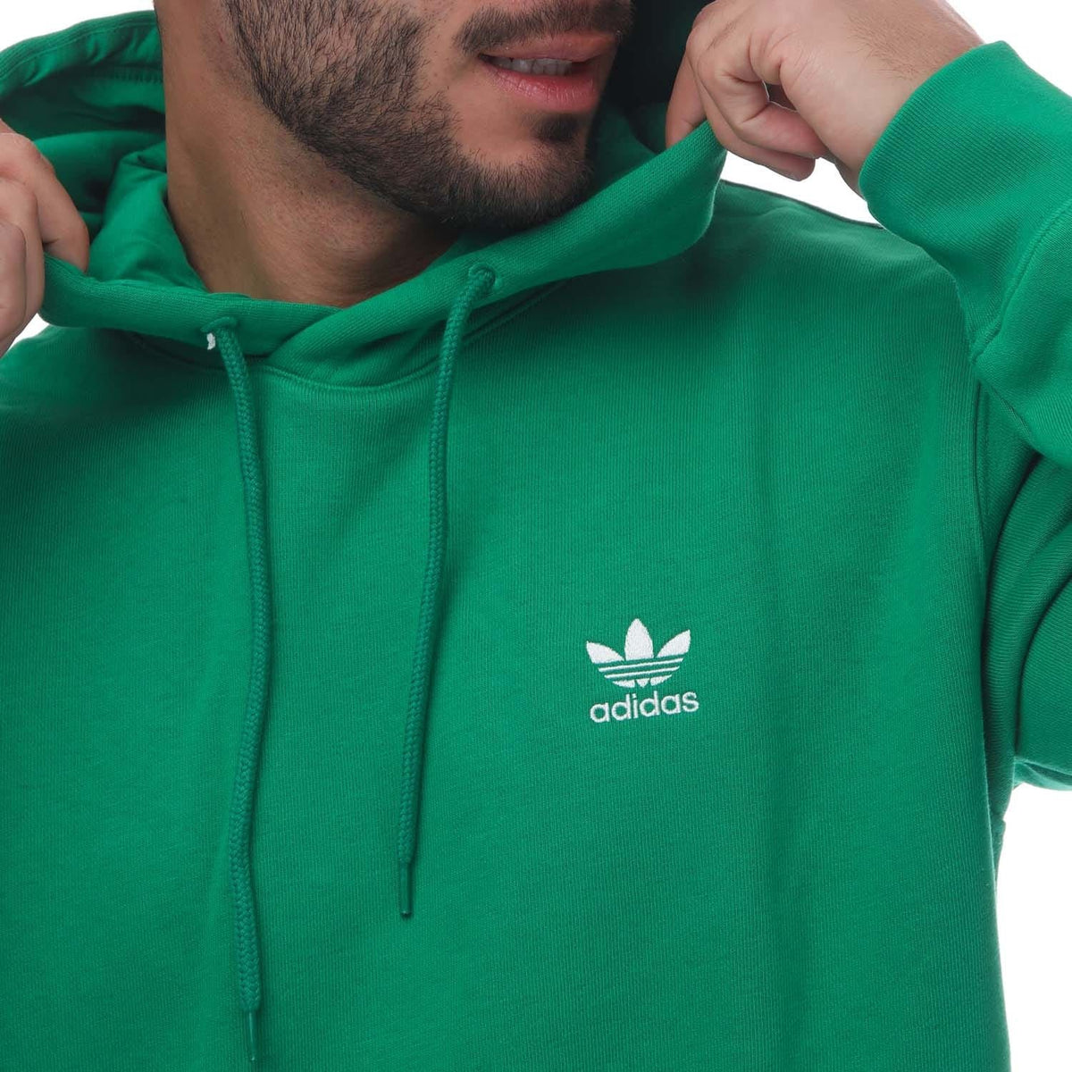 Green adidas Trefoil hoodie close-up with adidas logo on chest and hood drawstrings