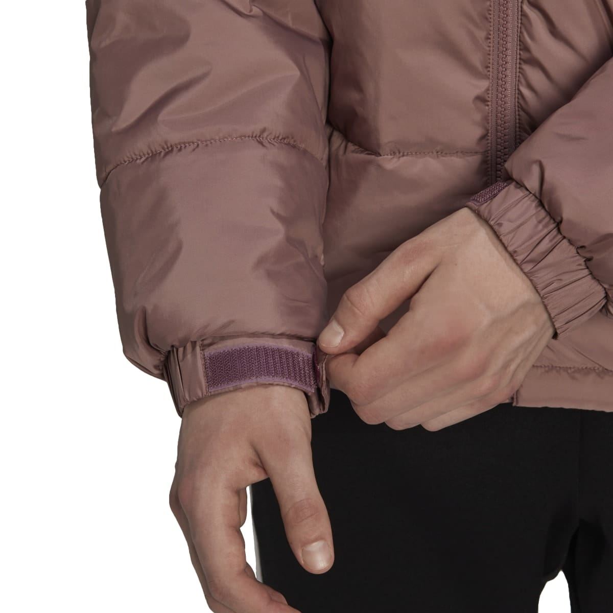 Burgundy padded puffer jacket sleeve close-up with ribbed cuff and zipper