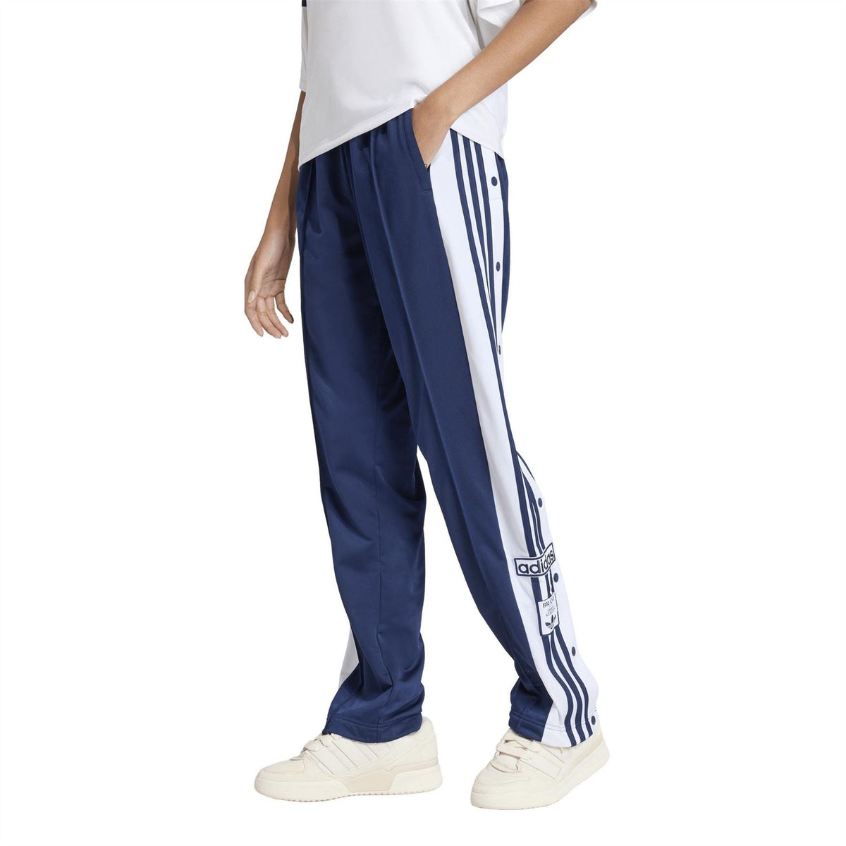 adidas Originals women’s track pants, dark blue with white vertical stripe panels on the sides