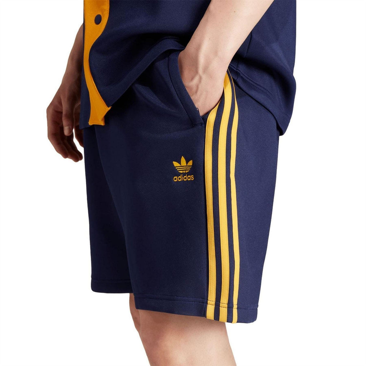 Dark blue shorts detail: yellow vertical side stripes and adidas logo on leg