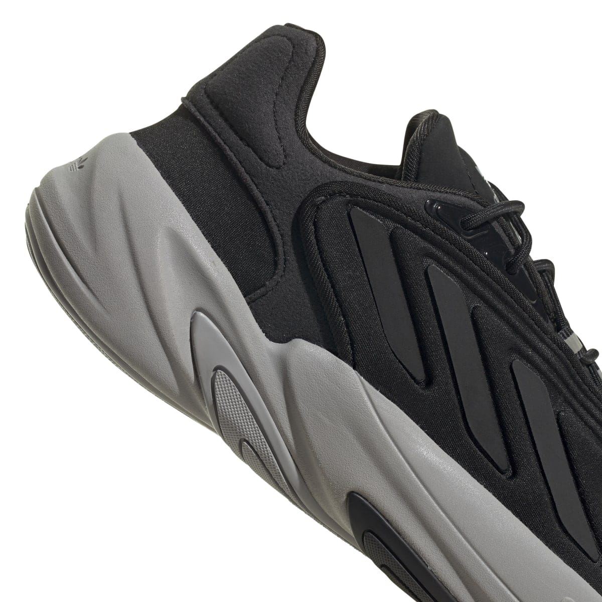Close-up of black trainer side with slip-on style panel and sculpted light-gray midsole