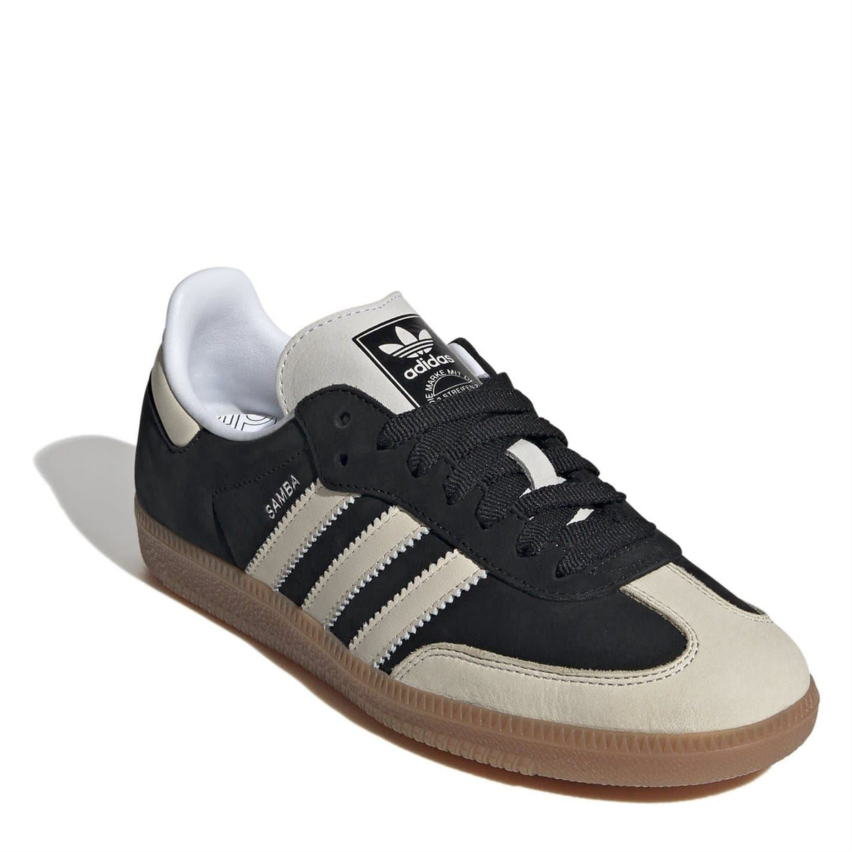 Black low-top sneakers with lace-up, tongue adidas logo, and three white stripes