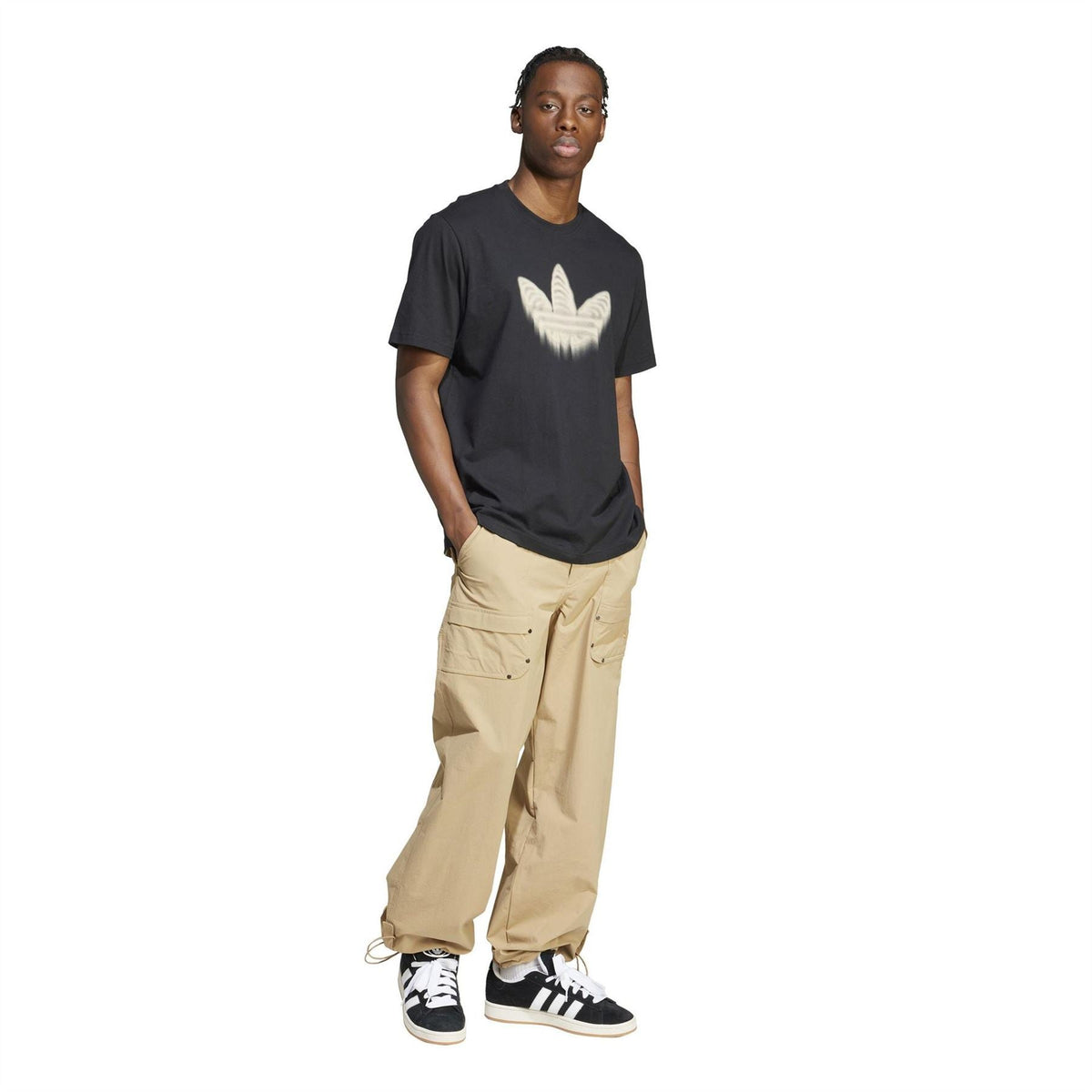 adidas Originals beige cargo pants with flap pockets, worn with sneakers and graphic tee