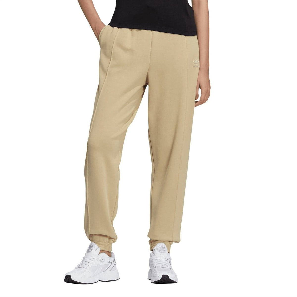 Beige adidas Originals sweatpants with tapered legs and elastic ankle cuffs