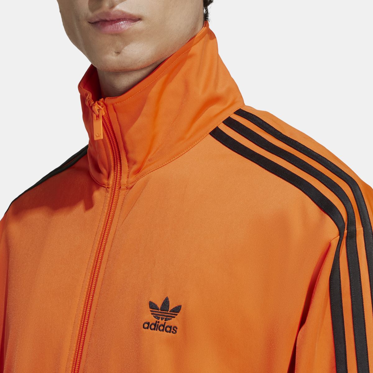 adidas Originals Adicolor Classics Firebird Track Top in vibrant colors, shown on a model with full sleeves and front zip closure