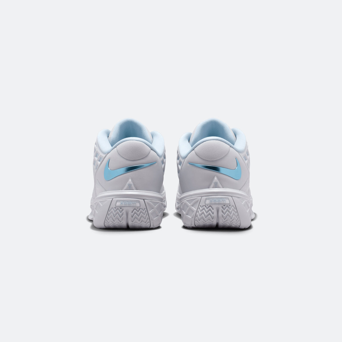 Light blue and white basketball shoes from the heel with molded outsole tread