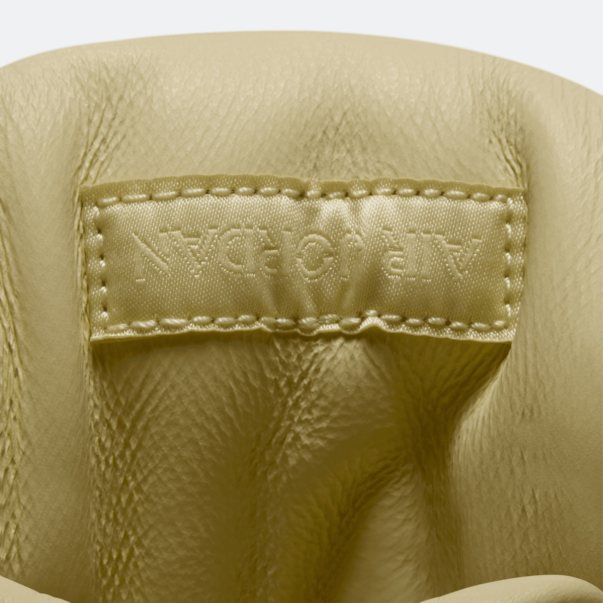 Close-up of yellow heel lining with embossed text inside the collar