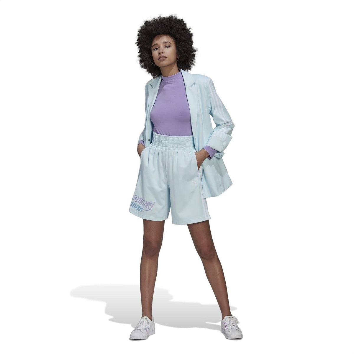 Light blue hem of athletic shorts with adidas-style stripes and printed side logo