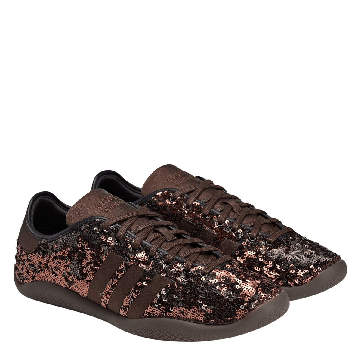 Sequin low-top sneakers with brown collar, metallic stripe pattern, and lace-up fronts