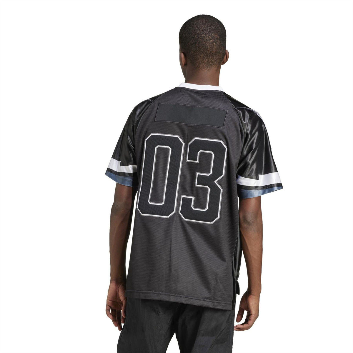 Back of black team jersey with large white "03" number and striped sleeves
