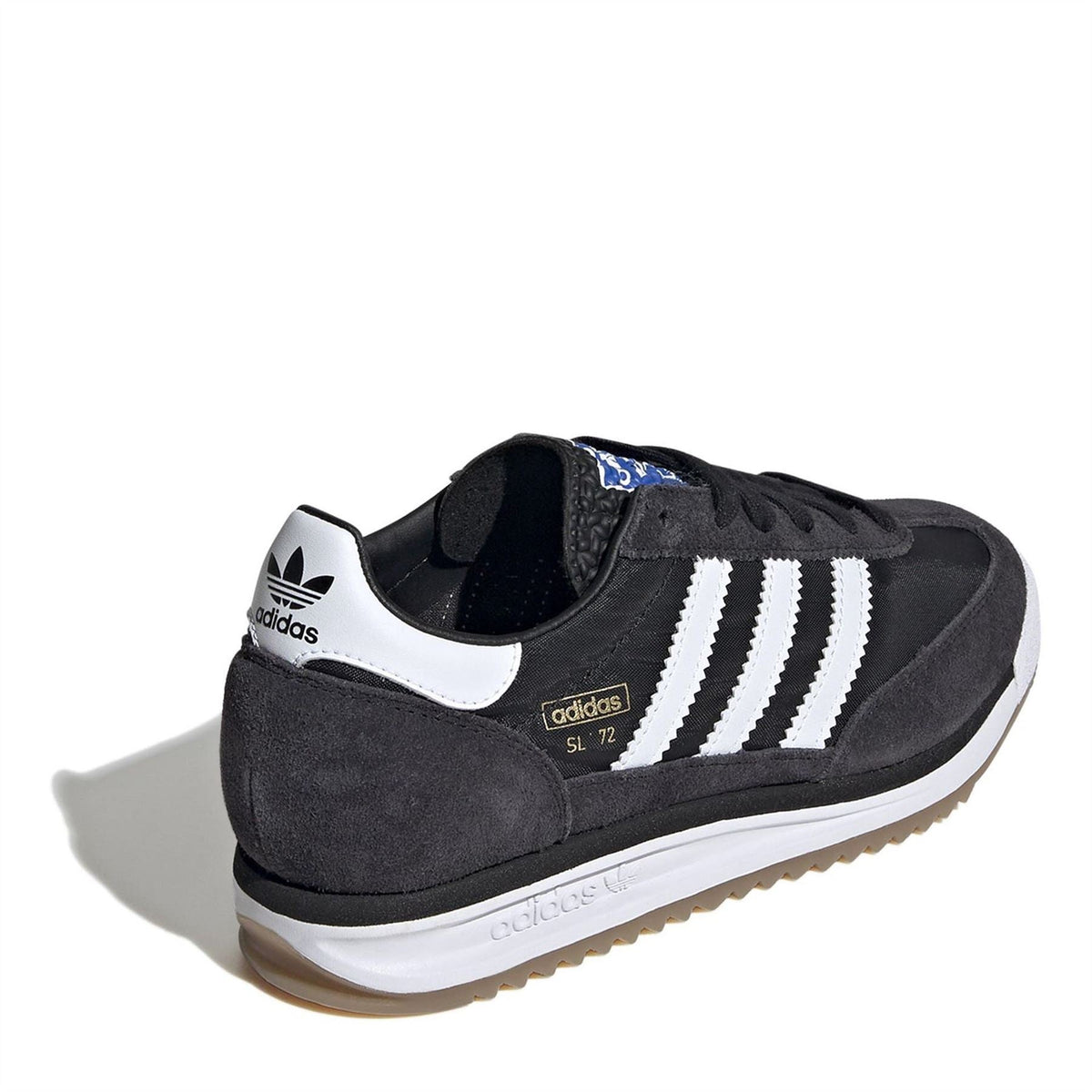 Black suede low-top sneakers with white heel tab, side stripes, gum sole