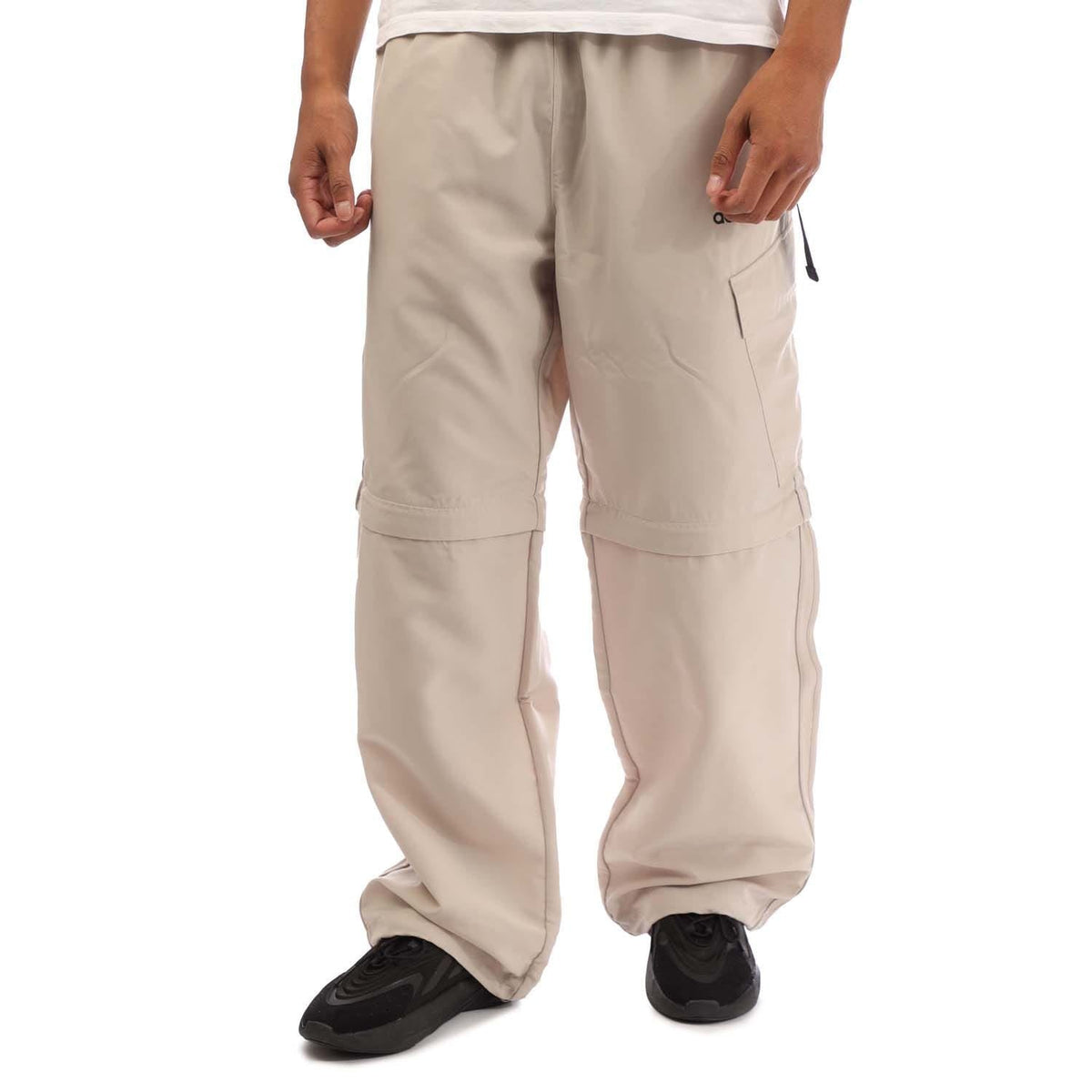 Beige zip-off jogger pants with cargo pockets and adjustable cuffs