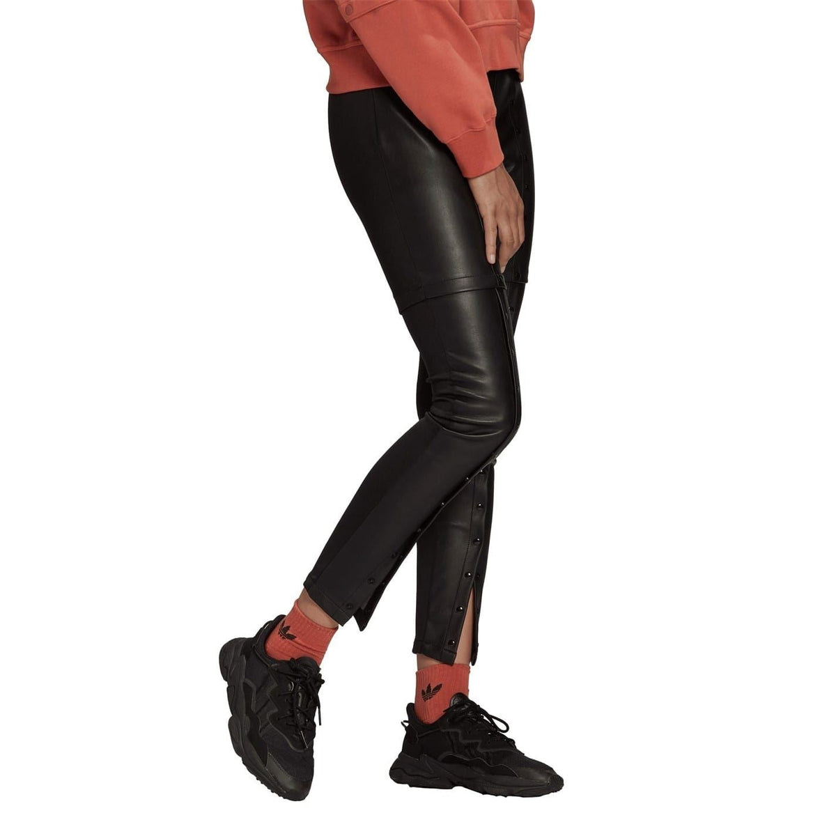 Black faux leather skinny trousers with side button row and tapered leg opening