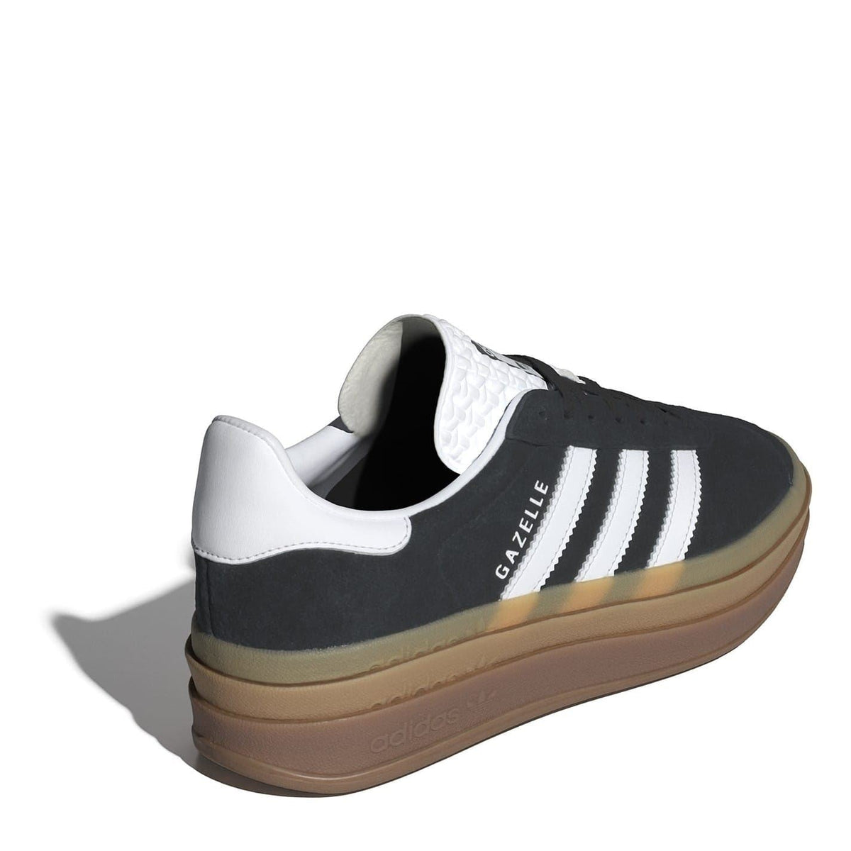 Black suede low-top sneakers with white heel lining and gum sole
