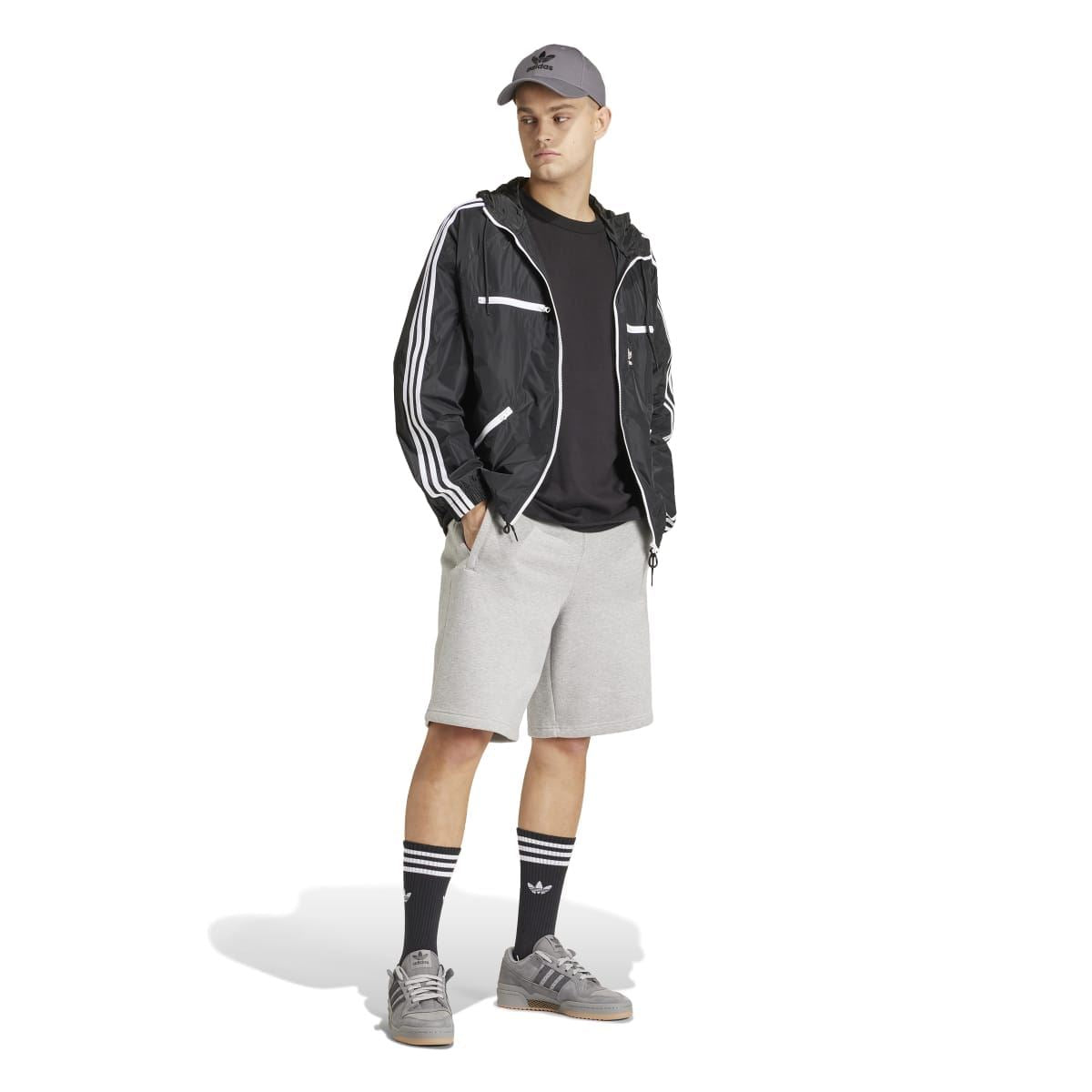 Black crew-neck T-shirt under a jacket; short sleeves and neckline visible