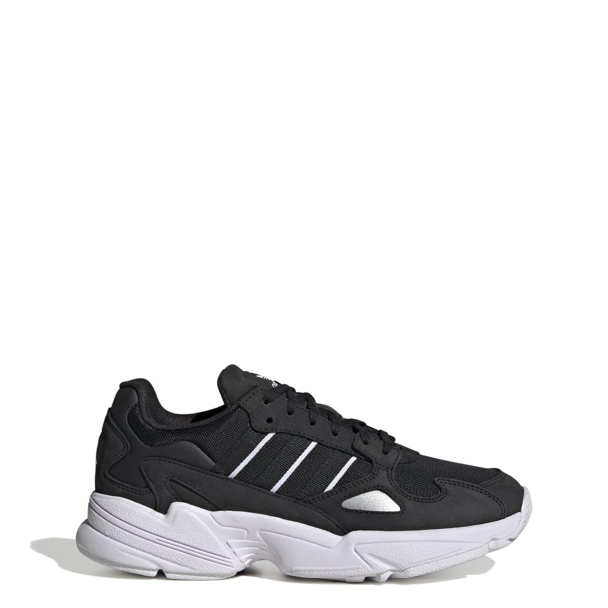 Black and white low-top sneakers angled side view with three stripes and white sole