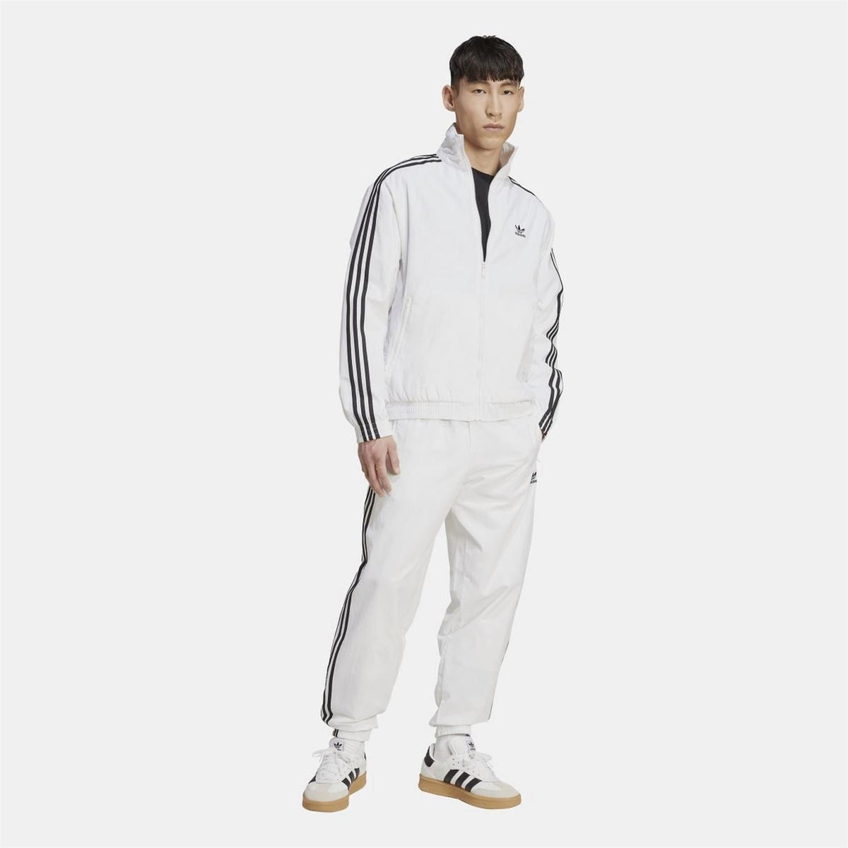 adidas Originals woven Firebird track top with vibrant color blocking and classic logo, displayed on a hanger against a neutral background