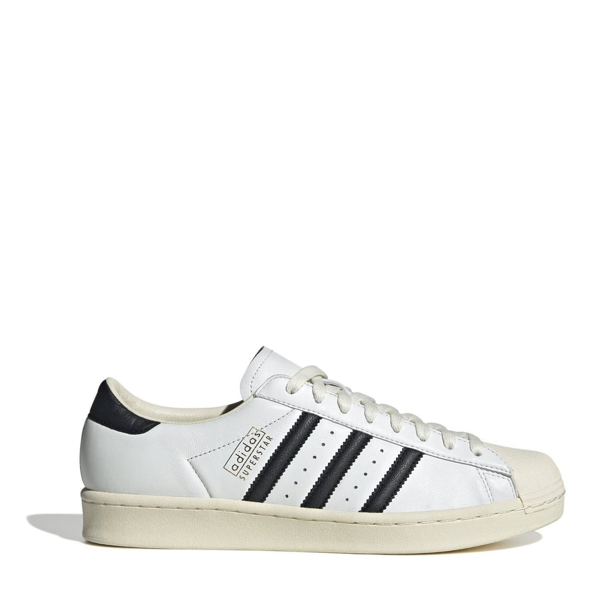 Cream leather-look sneakers with black adidas stripes and white lace-up