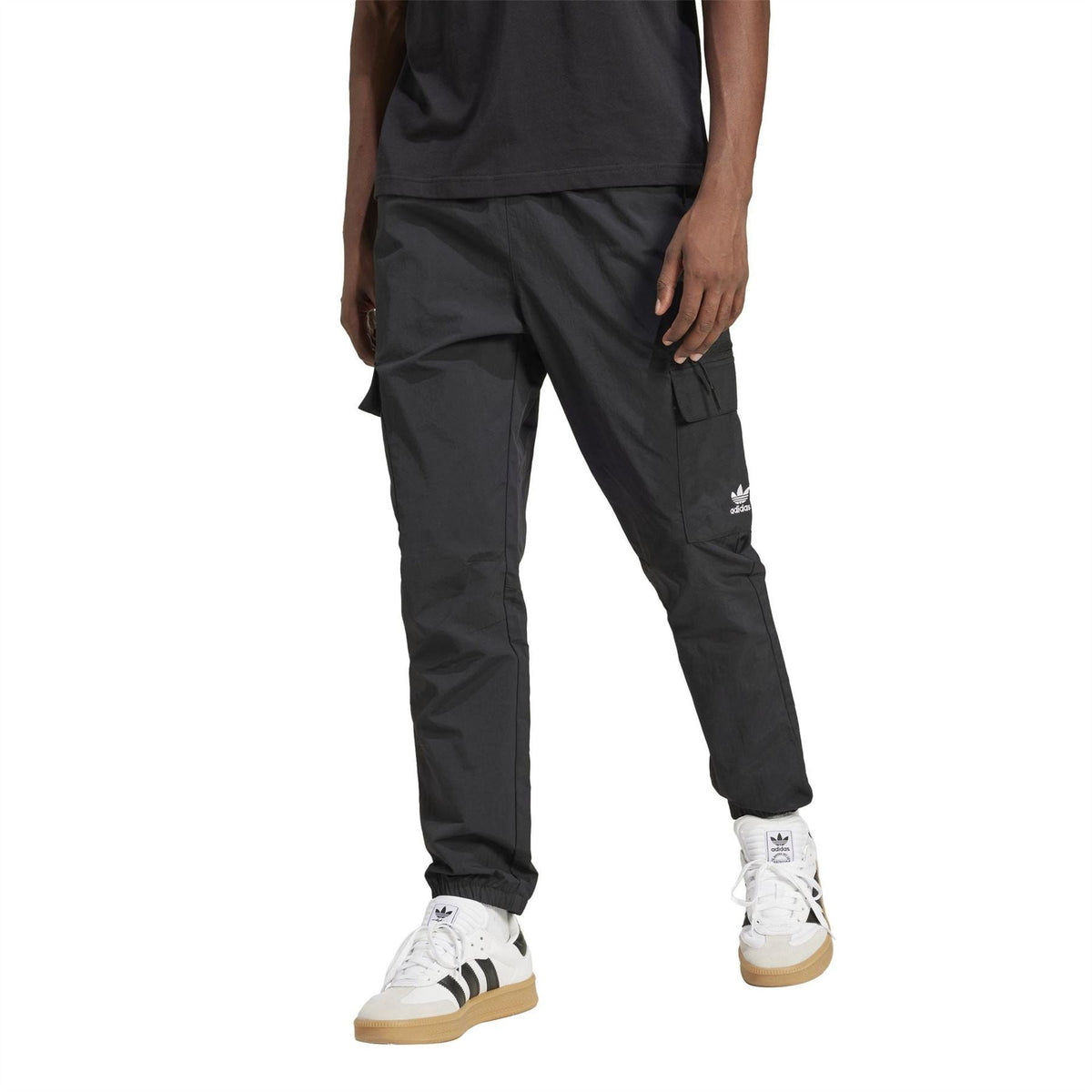 Black cargo pants with cuffed ankles and adidas trefoil logo
