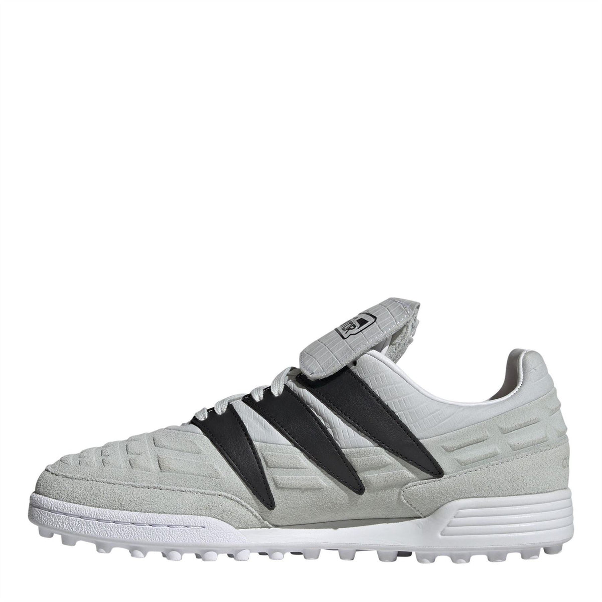 Low-top soccer cleat in light gray with black side stripes and white outsole studs