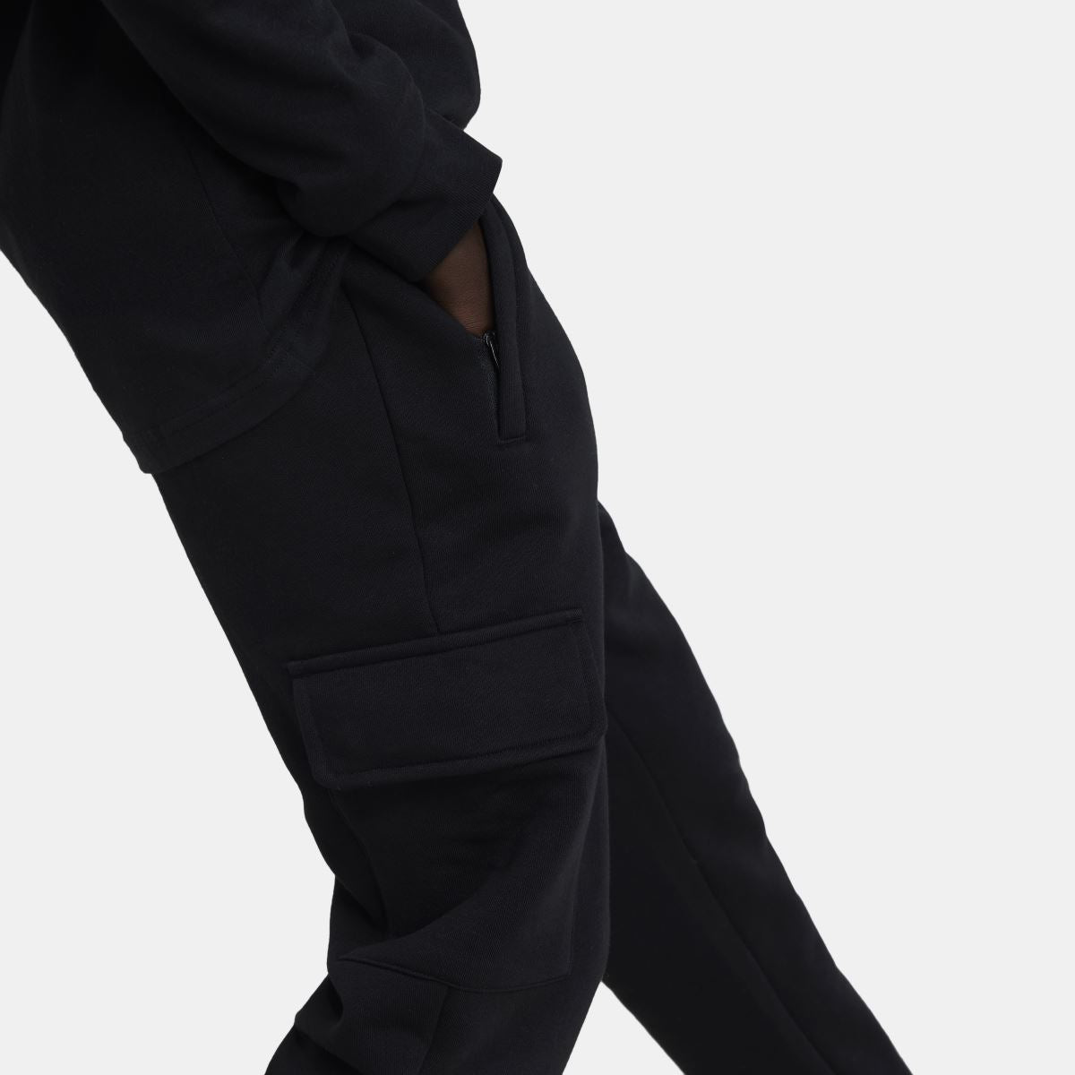 Black fleece cargo pants showing side cargo pocket and tapered, cuffed leg