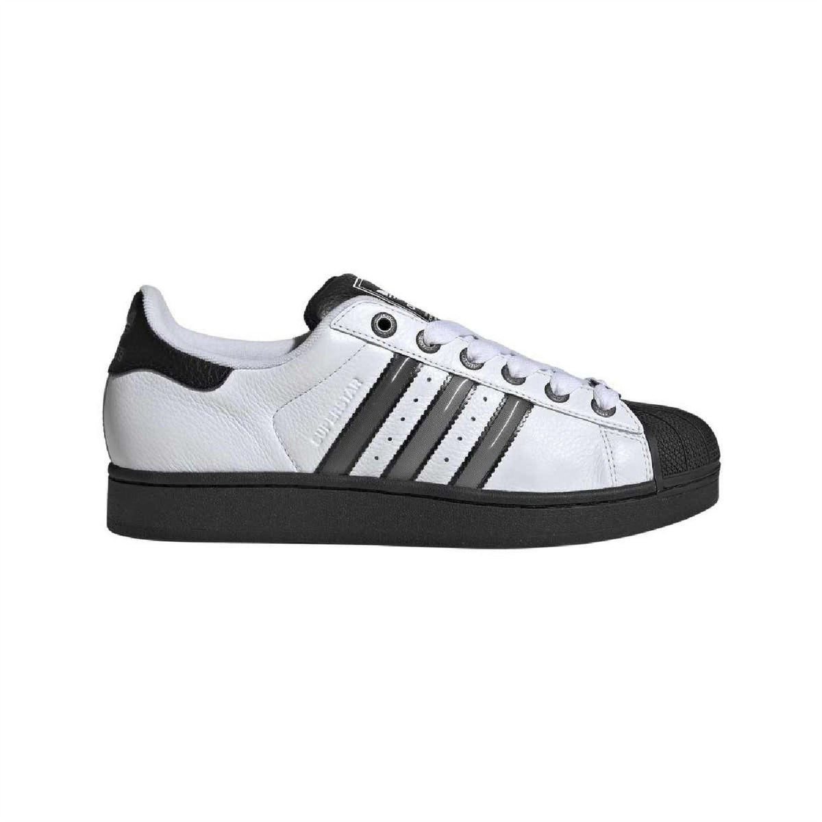 White leather low-top sneakers with black heel patch and three stripe accents