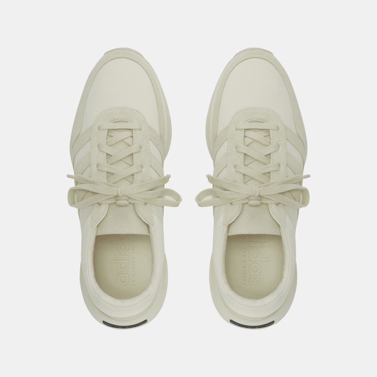 Pair of cream trainers with lace-up uppers and padded interior