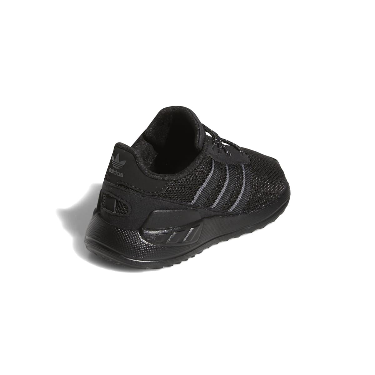 Infant sneakers with black cushioned heel, lace-up front, and gray stripe panels.