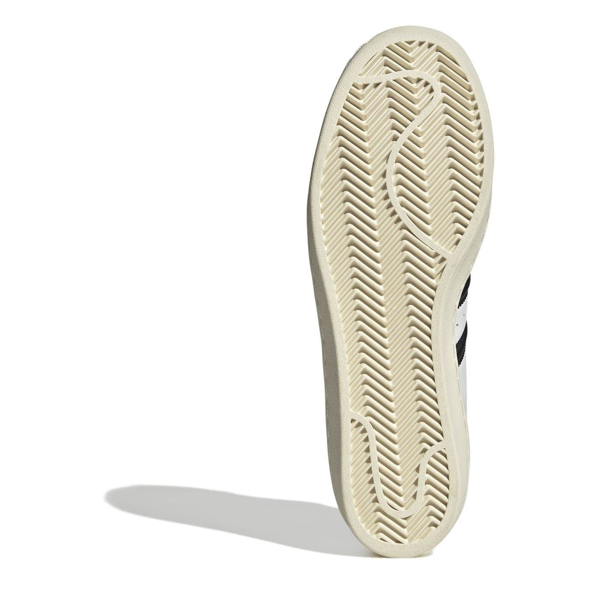 Cream sneaker outsole with textured herringbone tread pattern