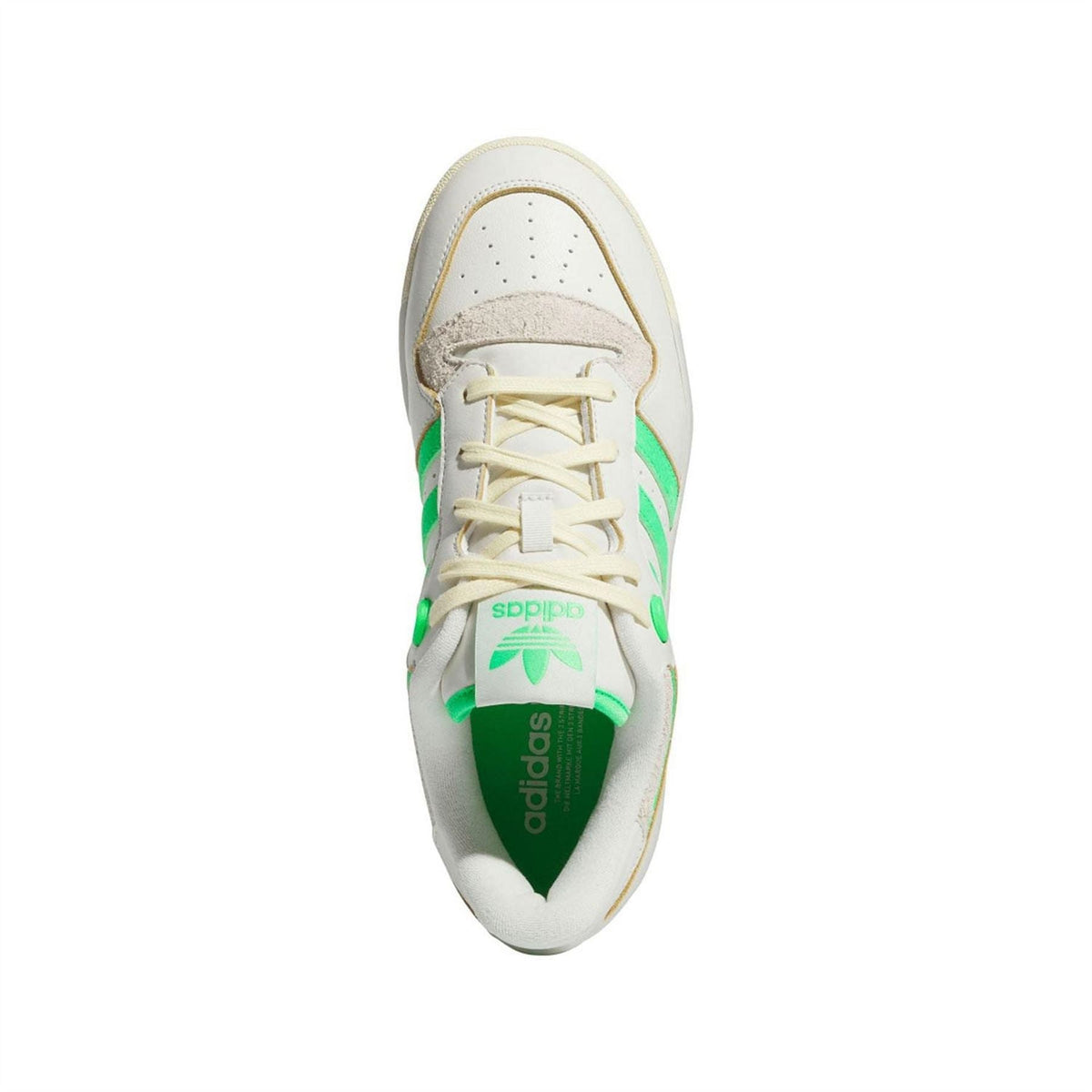 Lace-up sneaker with white upper and green accents, adidas branding on tongue
