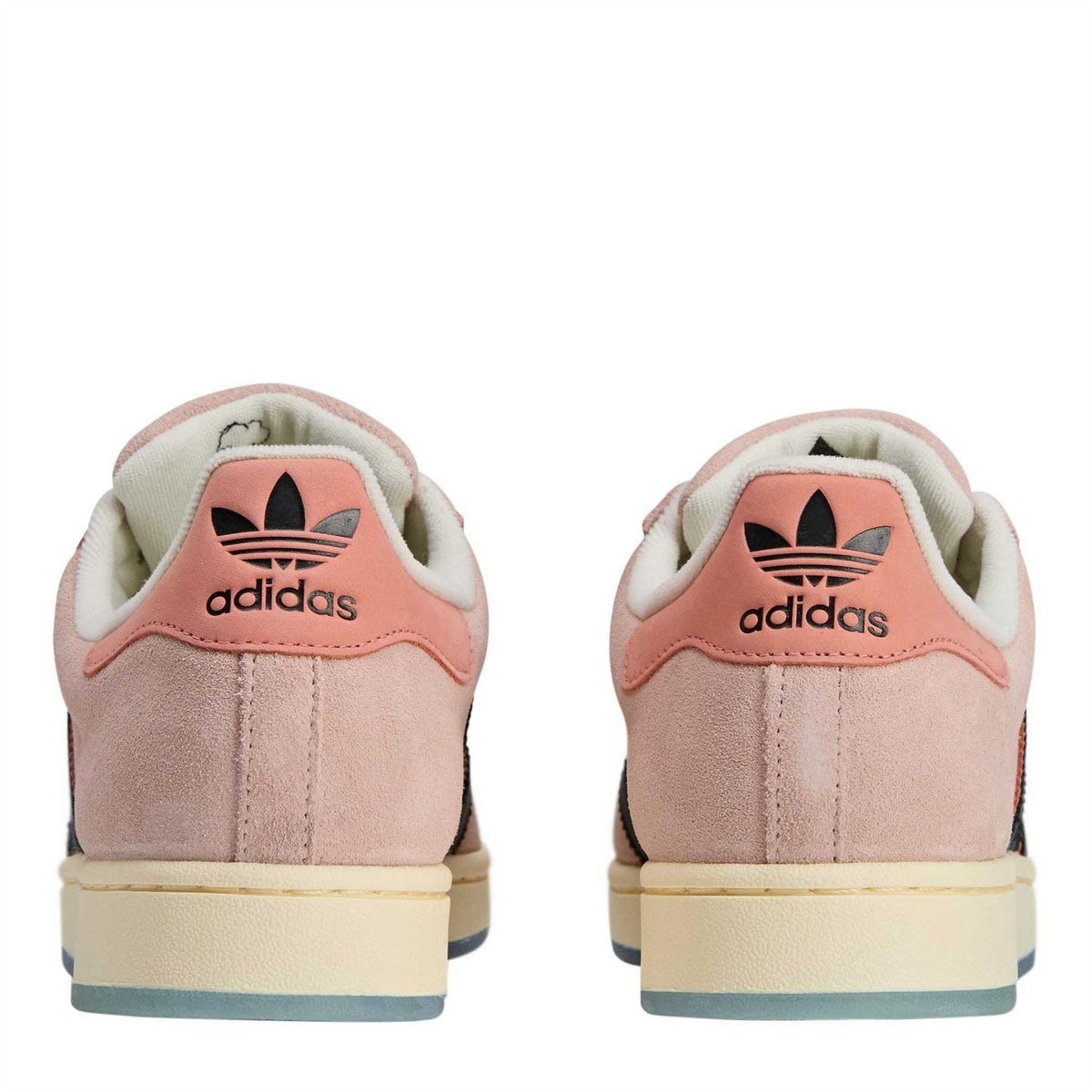 Back view of pink low-top sneakers with adidas heel logo and tan outsole