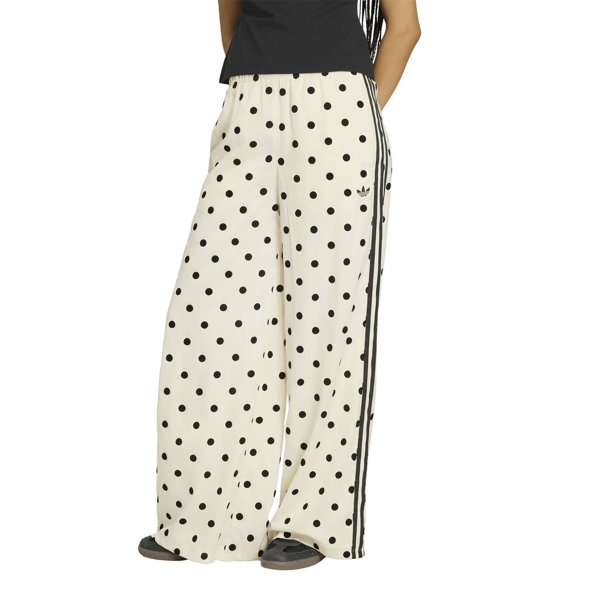 Off-white wide-leg pants with black polka dots, elastic waist, and contrasting side stripes