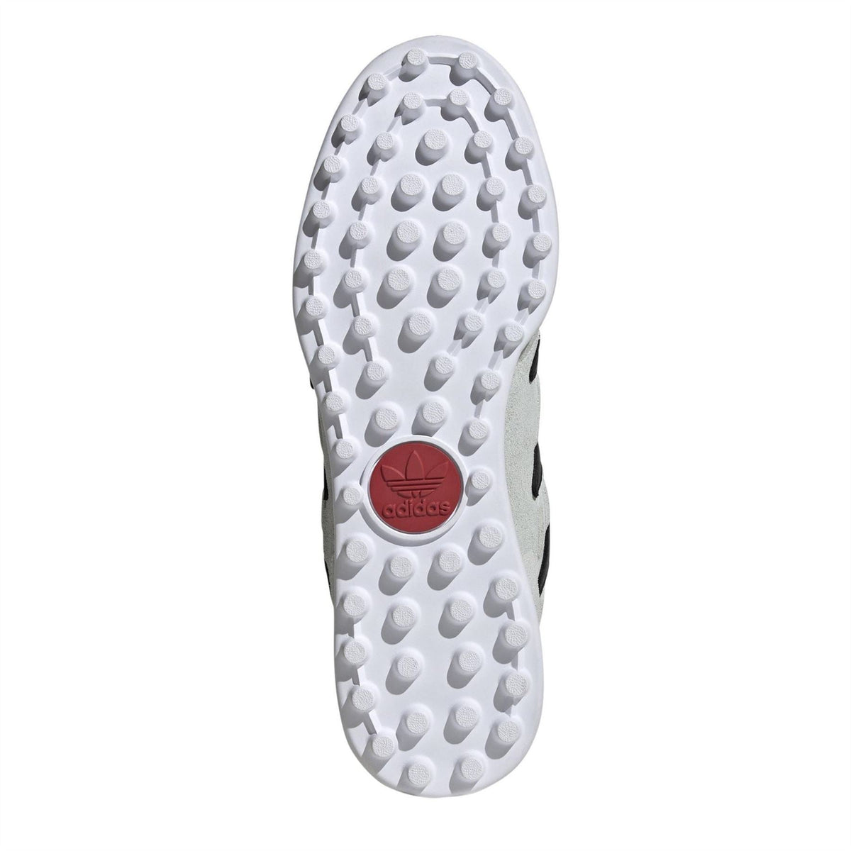 Cleat outsole in white with round traction studs and black heel detail